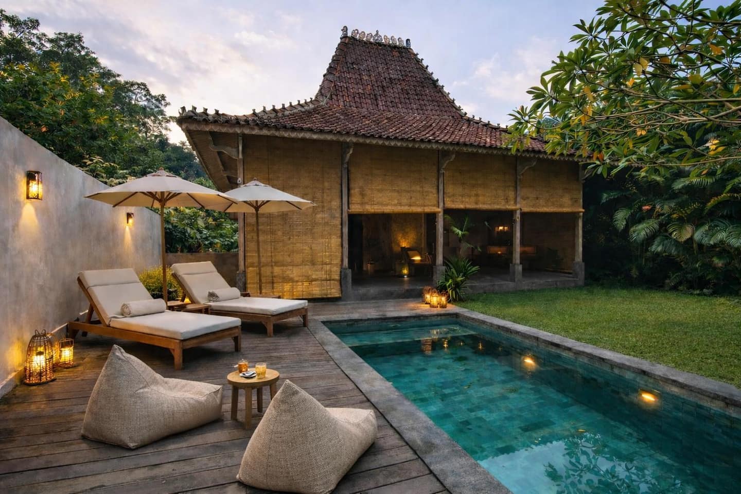 Pool and traditional joglo roof at dusk in Pererenan
